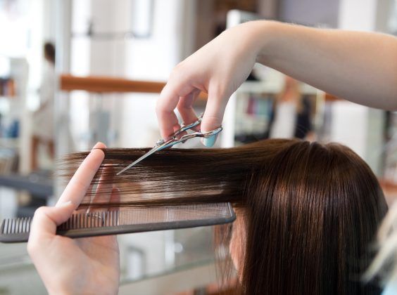 Christine Valmy cosmetology and hairstyling student cutting a client's hair