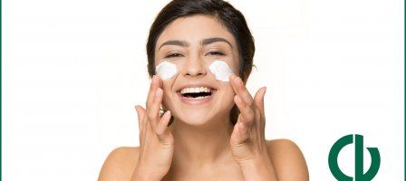 How to care for dry skin, girl happily applying face moisturizer