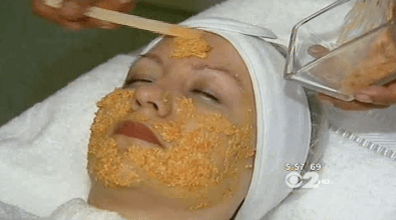 Marina Valmy applies a DIY facial mask to a client laying on a spa treatment bed