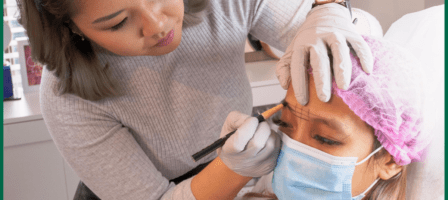 Hudson Beauty Bar staff member performing an eye brow service on a client